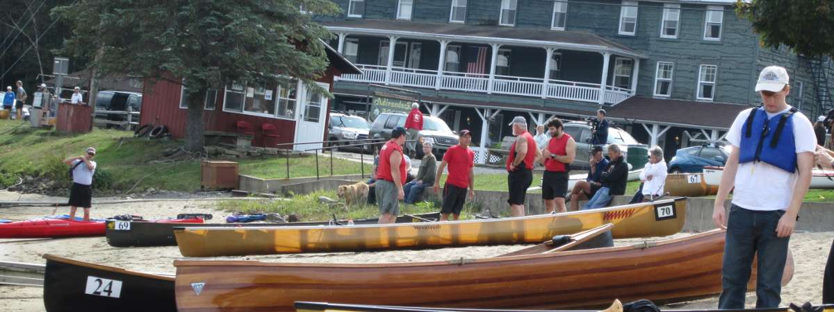 people standing near canoes