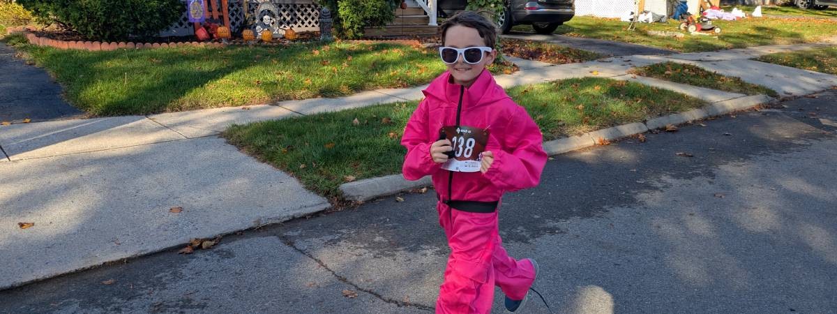 kid running dressed as squid game guard