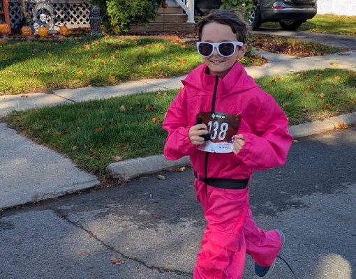 Photo credit: Alan Nudi kid running dressed as squid game guard