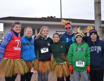 runners dressed in turkey-themed outfits for a race