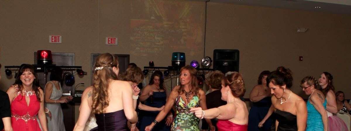 women in prom dresses on a dance floor