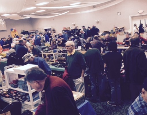 people checking out model train cars