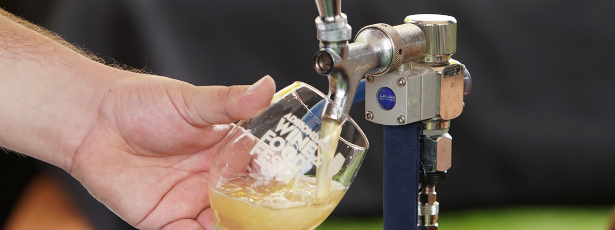 vendor pouring beer at the adirondack wine and food festival