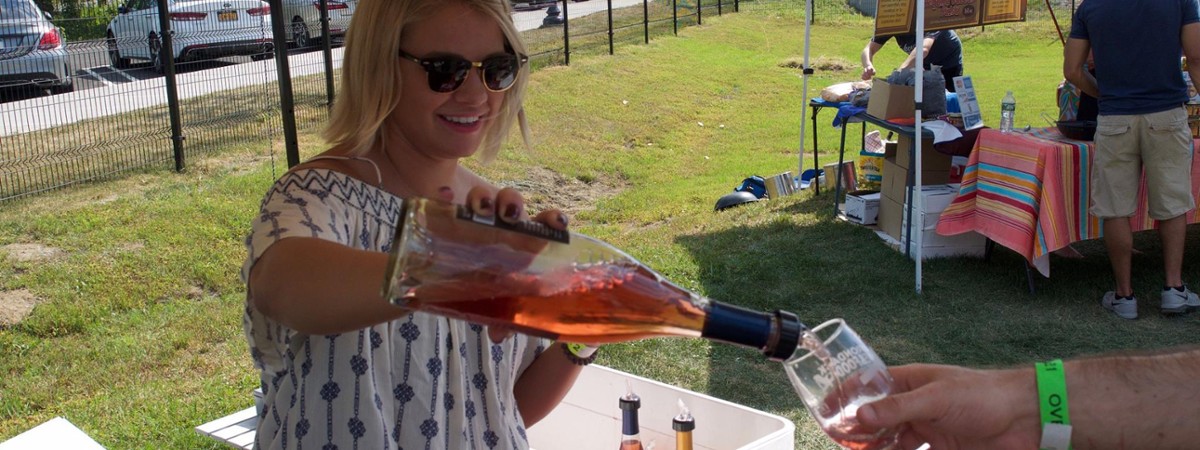 woman pouring a wine sample