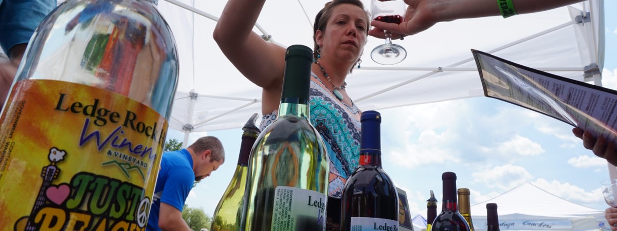 woman pouring a wine sample