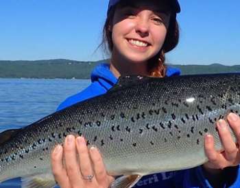 young woman holds up fish