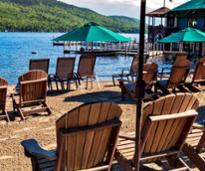 chairs and umbrellas on lake george beach