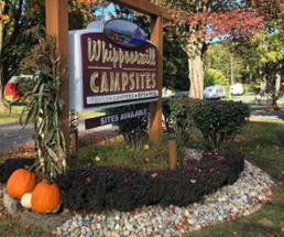 whippoorwill campsites sign in fall with pumpkins