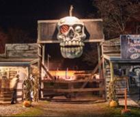 giant skull at the entrance of a haunted hayride attraction