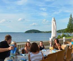 people dining on patio near the water