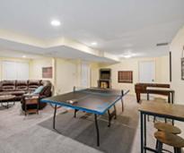 game room in a house with paddleball table, small arcade, foosball 