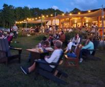 people sitting outside at dusk