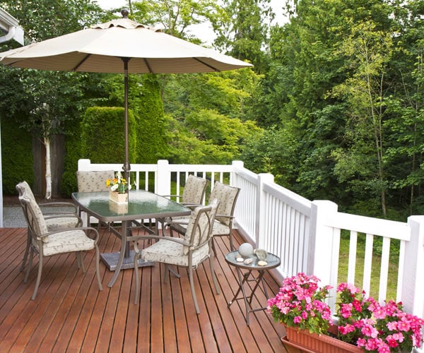 outdoor deck with table, chairs, and umbrella