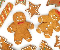 gingerbread cookies in the shape of trees, stars, and gingerbread men