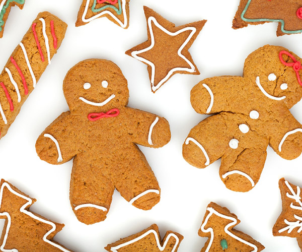 gingerbread cookies in the shape of trees, stars, and gingerbread men
