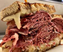 close up of a large corned beef sandwich