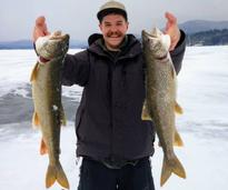 man holding up catch from ice fishing