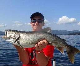 guy in red shirt holds up fish