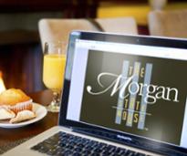 laptop that says morgan state house on the screen next to muffin and orange juice