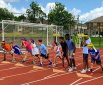 kids at day camp on a track field