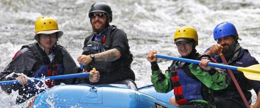 four people whitewater rafting