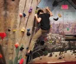 person rock climbing indoors