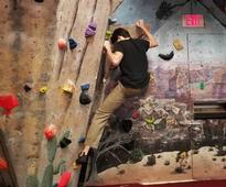 person rock climbing indoors