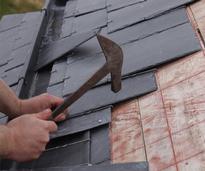person installing a slate roof
