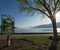spring sun and lake george village sign