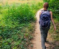 woman hikes with backpack on