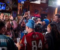 crowd of football watchers at a bar
