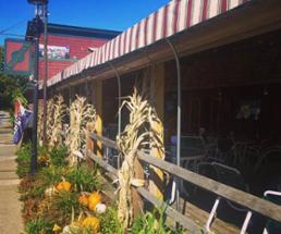 fredrick's restaurant patio with cornstalks and pumpkin decoratoins