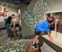 family looks at museum displays