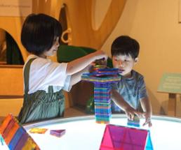 kids play with colorful magnet blocks in a kids museum