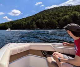 guy on boat looks at another boat
