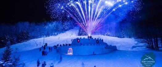 blue fireworks over ice castle in winter