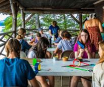 kids at summer camp doing arts and crafts outside