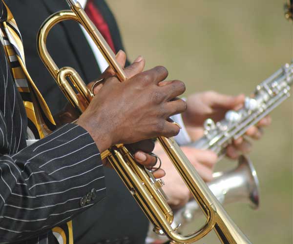 close up of hands on a saxophone