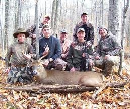 group of hunters and a deer