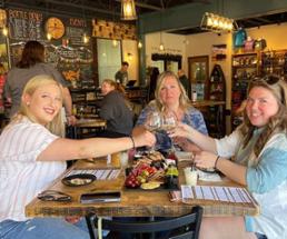 three women at a winery cheersing