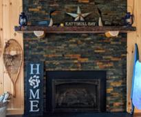 fireplace in home with katskill bay sign