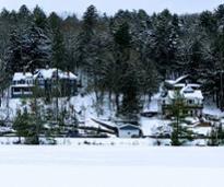houses by a lake in the winter in the adirondacks