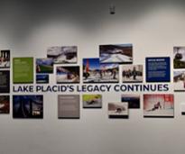 sign and photos in museum with text lake placid's legacy continues