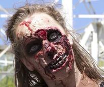 woman zombie in front of roller coaster