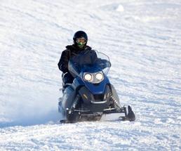 person snowmobiling
