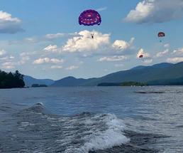 parasailers over lake