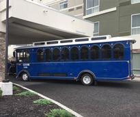 a blue trolley in front of a hotel