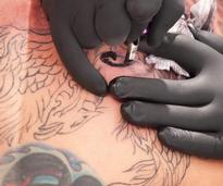 tattoo artist working