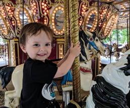 kid on merry go round