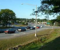 A major intersection with cars stopped at a red light in Queensbury NY
